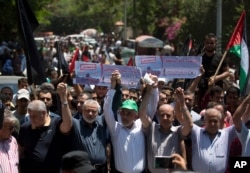 Head of the Hamas political bureau, Ismail Haniyeh, third from left, and Hamas leader in the Gaza Strip Yahya Sinwar protest the conference in Bahrain, which focuses on the White House's plan for Mideast peace, in Gaza City, June 26, 2019.