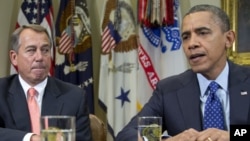 President Barack Obama, accompanied by House Speaker John Boehner of Ohio, speaks to reporters in the Roosevelt Room of the White House in Washington, November 16, 2012.