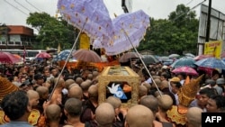 Buddhist monks carry the coffin of popular Buddhist abbot Sayadaw Bhaddanta Munindabhivamsa during his funeral in Myanmar's south central Bago region on June 27, 2024, after he was shot dead by security forces.