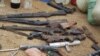 Confiscated weapons are displayed after a military raid on a hideout of suspected Islamist Boko Haram members in Nigeria's northern city of Kano August 11, 2012.