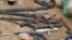 Confiscated weapons are displayed after a military raid on a hideout of suspected Islamist Boko Haram members in Nigeria's northern city of Kano August 11, 2012.
