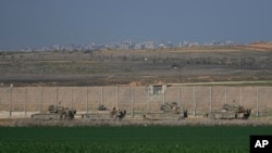 Israeli army APCs are moving along the border with the Gaza Strip in southern Israel, Jan. 16, 2025. 