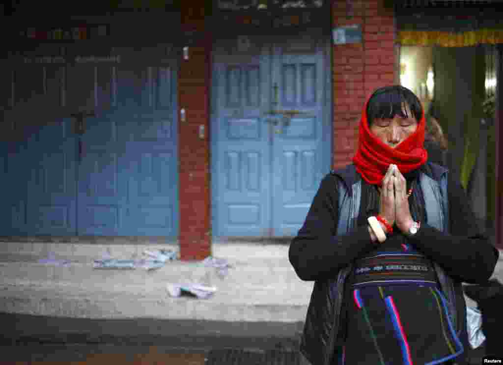 A Tibetan woman offers prayers in front of the Boudhanath Stupa in Kathmandu, Nepal, February 8, 2012. (Reuters)