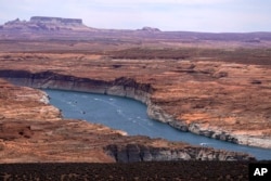 FILE - Boats sail on Lake Powell in the Upper Colorado River Basin in Wahweap, Arizona, June 9, 2021. (AP Photo/Ross D. Franklin, File)