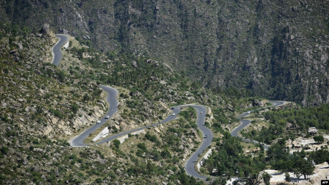 This picture taken on May 18, 2018, shows a road track at a tree plantation site in Buner in northwest Pakistan. The change is drastic: Around the region of Heroshah, previously arid hills are now covered with forest.