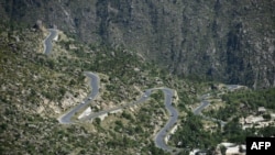 This picture taken on May 18, 2018, shows a road track at a tree plantation site in Buner in northwest Pakistan. The change is drastic: Around the region of Heroshah, previously arid hills are now covered with forest.