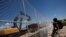 A child looks at U.S. workers building a section of the U.S.-Mexico border wall at Sunland Park, U.S. opposite the Mexican border city of Ciudad Juarez, Mexico, Aug. 26, 2016. Picture taken from the Mexico side of the U.S.-Mexico border. 