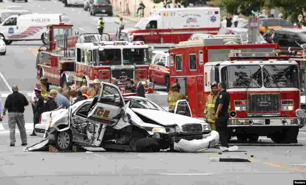 Rescue personnel stand around a smashed Capitol Police vehicle following a shooting near the Capitol.