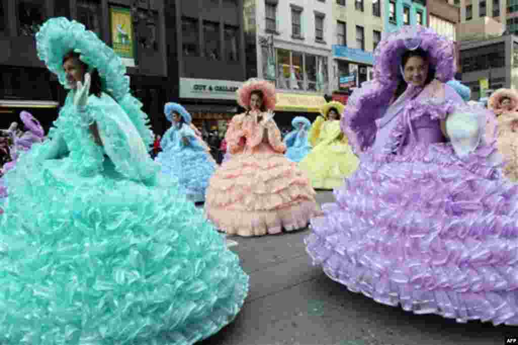 Members of the Mobile Azalea Trail Maids wave as they make their way down New York's Sixth Avenue during the 85th Annual Macy's Thanksgiving Day Parade Thursday Nov. 24, 2011. The group is from Mobile, Alabama. (AP Photo/Tina Fineberg)