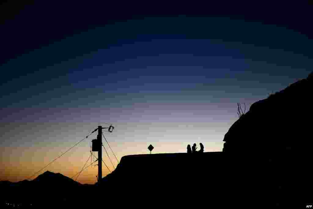 People watch sunset in El Paso, Texas.