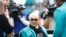 FILE - Former Miami Dolphins head coach Don Shula looks at a large cake celebrating the 1972 undefeated season and his birthday during half time at an NFL football game against the Cincinnati Bengals in Miami Gardens, Florida, Dec. 22, 2019.