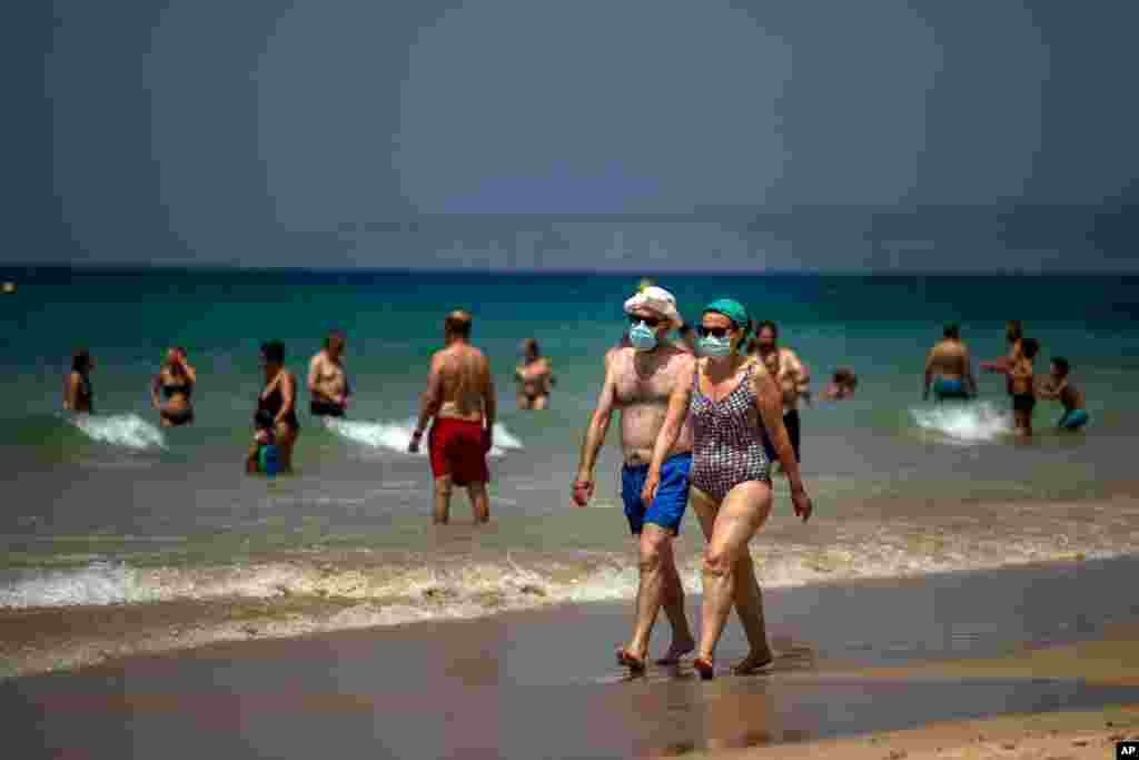 عکسی از ساحل کادیز در جنوب اسپانیا که مردم با ماسک در ساحل حضور دارند. 
