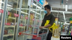 A man looks at frozen food products in a supermarket following an outbreak of the coronavirus disease (COVID-19) in Beijing, China, August 13, 2020.