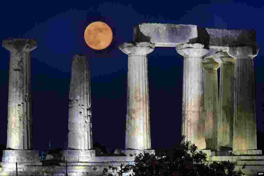 June&#39;s full moon, known as the Strawberry Moon, rises above the Apollo Temple in ancient Corinth, Greece, June 17, 2019.