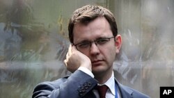 Andy Coulson, former editor of the tabloid News of the World, and later David Cameron's director of communications, speaks on a mobile phone in London, April 13, 2010 (file photo)