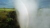 FILE - In this April 1995, file photo, a rainbow forms in a cloud of mist over the Victoria Falls, Zimbabwe. 