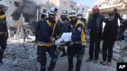 Fotografía muestra a Cascos Blancos cargando a una víctima tras un ataque de las fuerzas del gobierno sirio en la ciudad de Idlib, Siria, el lunes 2 de diciembre de 2024