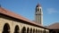 FILE - People walk on the Stanford University campus beneath Hoover Tower in Stanford, California, March 14, 2019.. 