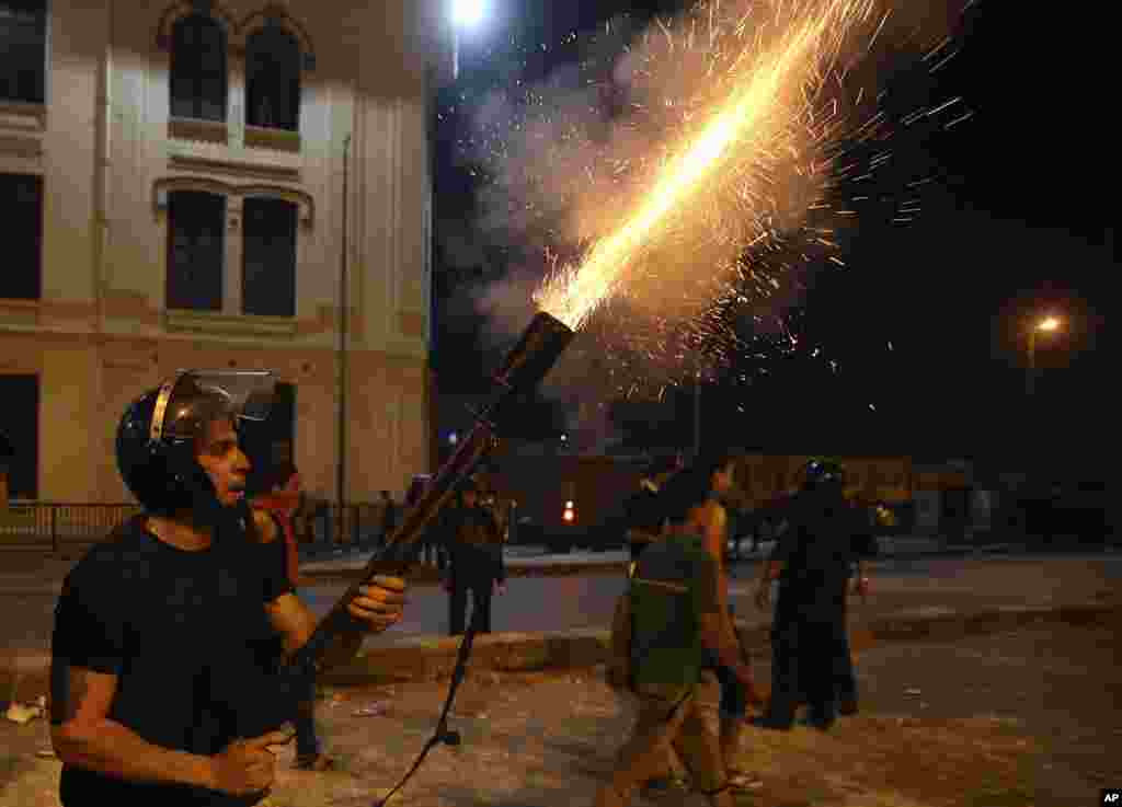 Egyptian security forces fire tear gas towards supporters of ousted President Mohamed Morsi during clashes in downtown Cairo, July 15, 2013.