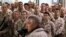 U.S. troops listen to U.S. Defense Secretary Chuck Hagel as he speaks at Camp Bastion, Helmand Province December 8, 2013. 