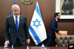 FILE - Israeli Prime Minister Benjamin Netanyahu, left, takes a seat before his meeting with France's Foreign Minister Stephane Sejourne, right, in Jerusalem February 5, 2024.