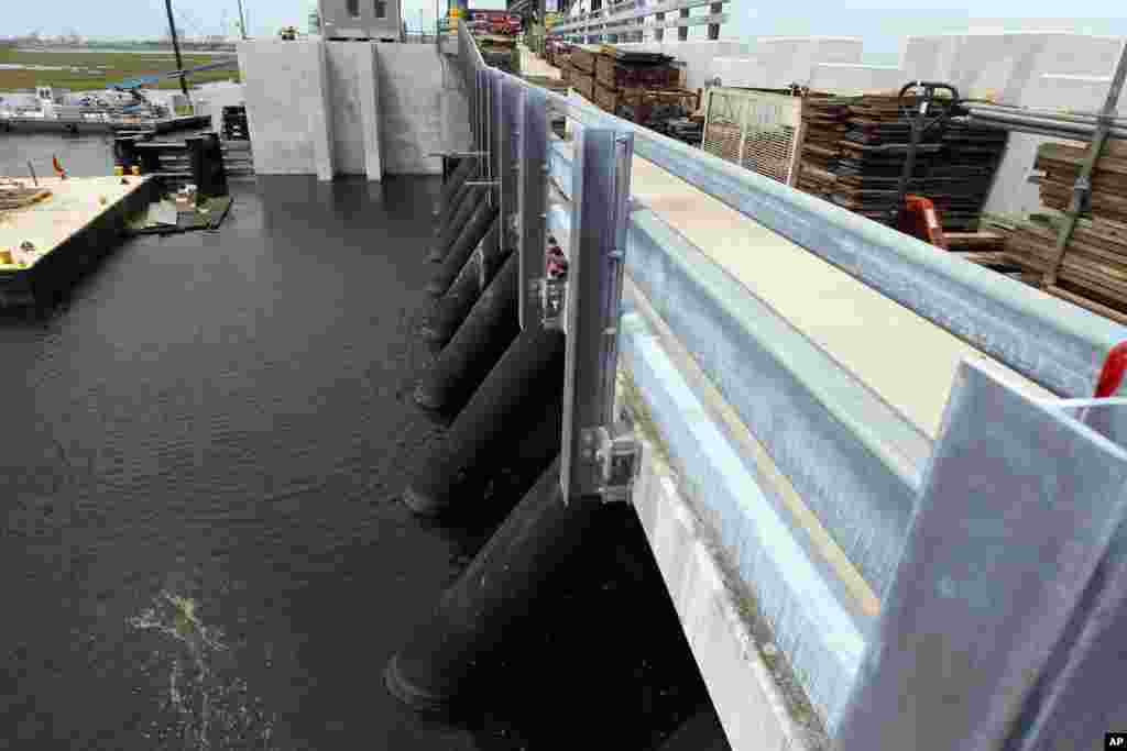 The Army Corps of Engineers was given about $14 billion to improve flood defenses after Katrina. The corps says the city is ready to handle a storm that experts say would resemble a Category 3 hurricane. (AP Photo/Gerald Herbert)