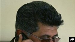 Razaq Mamoon, an Afghan journalist and author, speaks on his mobile phone at his office in Kabul, Afghanistan (File Photo).