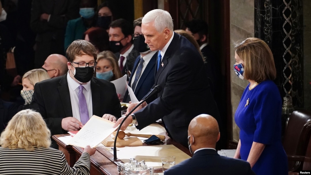 FILE - U.S. Vice President Mike Pence and Speaker of the House Nancy Pelosi take part in a joint session of Congress to certify the 2020 election results on Capitol Hill in Washington, Jan. 6, 2021. 
