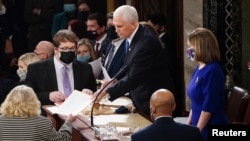 U.S. Vice President Mike Pence and Speaker of the House Nancy Pelosi take part in a joint session of Congress to certify the 2020 election results on Capitol Hill in Washington, Jan. 6, 2021. 