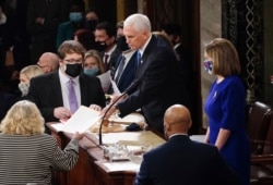 U.S. Vice President Mike Pence and Speaker of the House Nancy Pelosi (D-CA) take part in a joint session of Congress to certify the 2020 election results on Capitol Hill in Washington, Jan. 6, 2021.