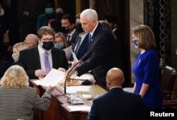 FILE - U.S. Vice President Mike Pence and Speaker of the House Nancy Pelosi (D-CA) take part in a joint session of Congress to certify the 2020 election results on Capitol Hill in Washington, Jan. 6, 2021.
