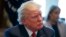 FILE - President Donald Trump listens in the Cabinet Room of the White House in Washington, March 29, 2017.