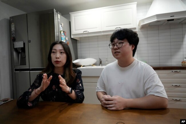 Yoo Young Yi speaks as her husband Jo Jun Hwi listens during an interview at their home in Seoul, South Korea on October 2, 2022. (AP Photo/Ahn Young-joon)