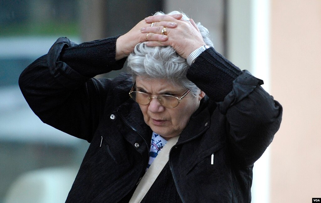 A woman holds her head in despair in Finale Emilia northern Italy, May 20 2012. AP Photo/Marco Vasini