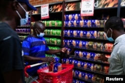 Maxwell Hwayo, 52, shops at a grocery store in Harare, Zimbabwe, March 17, 2022. (REUTERS/Philimon Bulawayo)