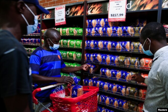 Maxwell Hwayo, 52, shops at a grocery store in Harare, Zimbabwe, March 17, 2022. (REUTERS/Philimon Bulawayo)