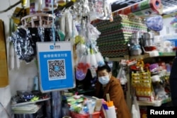 A QR code of digital payment device Alipay by Ant Group, an affiliate of Alibaba Group Holding, is seen at a grocery shop inside a market, in Beijing, China, Nov. 2, 2020.