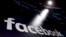 FILE - Facebook appears on screens at the Nasdaq MarketSite in New York's Times Square. 