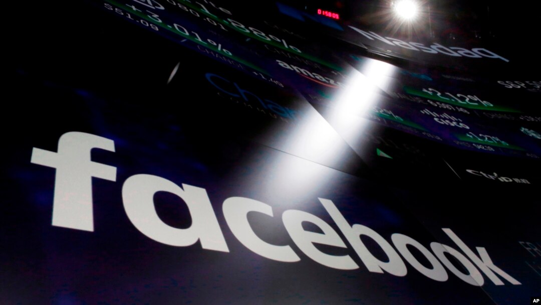 FILE - Facebook appears on screens at the Nasdaq MarketSite in New York's Times Square. 