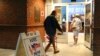 FILE - Voters walk into a polling station for the Florida presidential primary in Bonita Springs, Fla. 