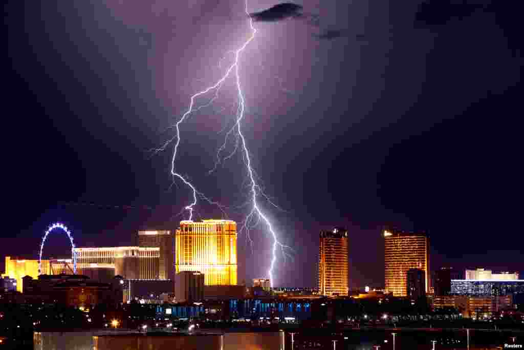 Lightning strikes behind casinos along the strip as a thunderstorm passes through Las Vegas, Nevada, Sept. 13, 2017.