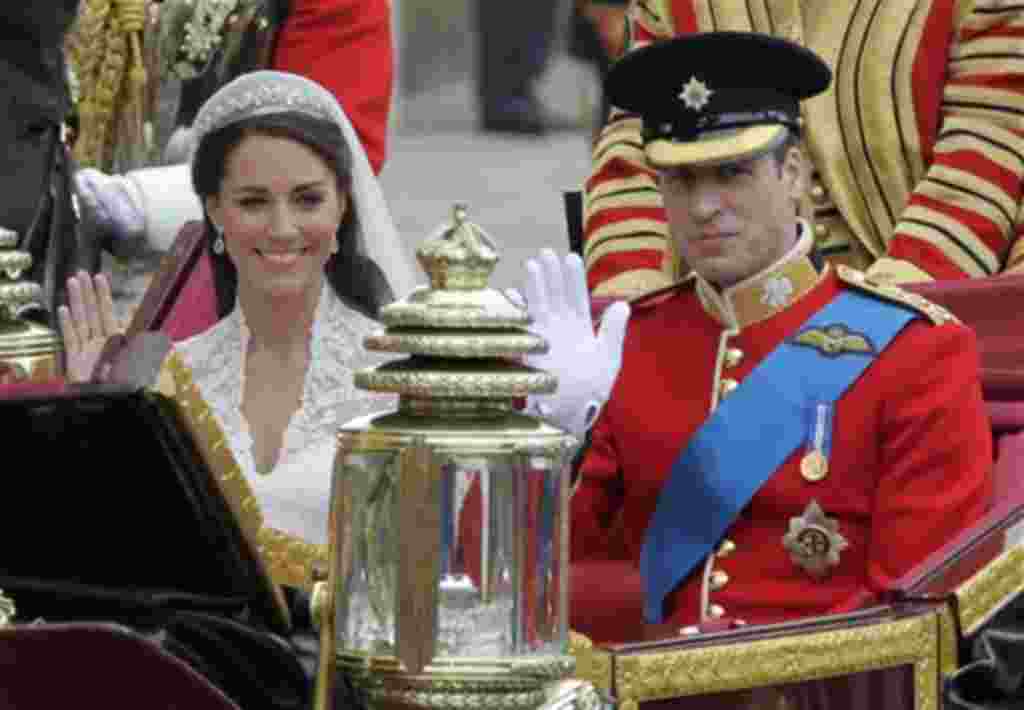 Britain's Prince William and his wife Kate, Duchess of Cambridge, left, wave as they leave Westminster Abbey at the Royal Wedding in London Friday, April 29, 2011. (AP Photo/Alastair Grant)