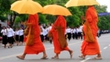 Cambodian Buddhist monks walk by the crowd, file photo. 