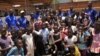 Girls trying out for a possible future in Malawi's National Female Football Team pose with their coaches during a talent search in Zomba, Malawi. (L. Masina/VOA)