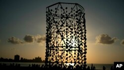 People walk around an art installation during the inauguration of the exhibition "Behind the Wall," at the 13th Havana Biennial, in Havana, Cuba, April 14, 2019. 