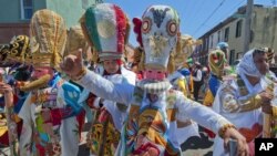 FILE - Marchers in Philadelphia's El Carnaval de Puebla en Filadelfia don costumes depicting the Mexican army that prevailed over the French and Turkish forces during the 1862 Battle of Puebla, commonly known as Cinco de Mayo.