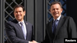 US Secretary of State Marco Rubio is greeted by Portugal's Prime Minister Luis Montenegro at the Sao Bento Palace in Lisbon,