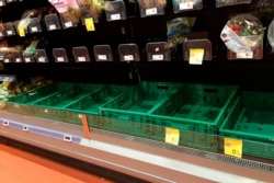 Empty shelves are seen in a supermarket in Milan, Feb. 23, 2020, as fears spread of rising numbers of coronavirus cases in Italy.