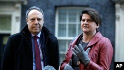 DUP Party leader Arlene Foster and Deputy Leader Nigel Dodds, left, make a statement to the media after exiting 10 Downing Street. London, Jan. 17, 2019. British Prime Minister Theresa May is reaching out to opposition parties and other lawmakers to put Brexit back on track.