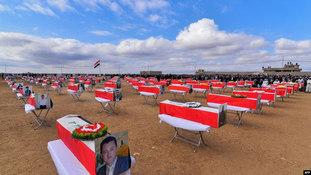 FILE - A mass funeral is held for Yazidi victims of the Islamic State group, in the northern Iraqi village of Kojo in Sinjar district, Feb. 6, 2021. The remains of 104 Yazidi victims have been returned, six years after IS swept through northern Iraq. 